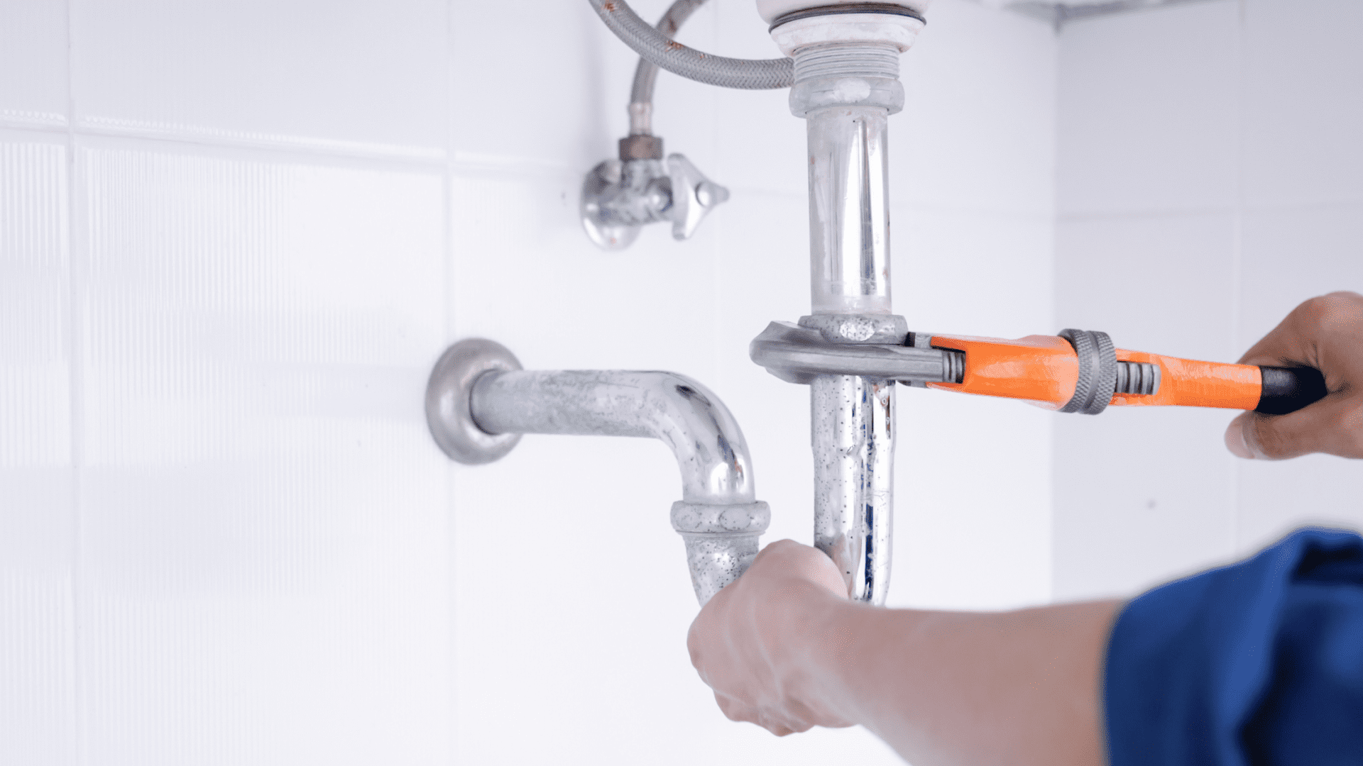 A man performing professional drain repair in University Park, TX.