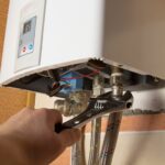 Experienced plumber performing a water filtration system installation in Highland Park, TX